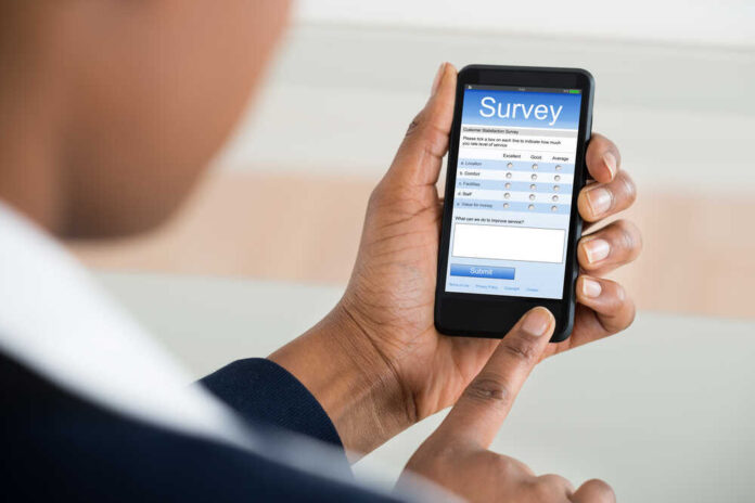Close-up,Of,A,Businesswoman,Filling,Online,Survey,Form,On,Mobile