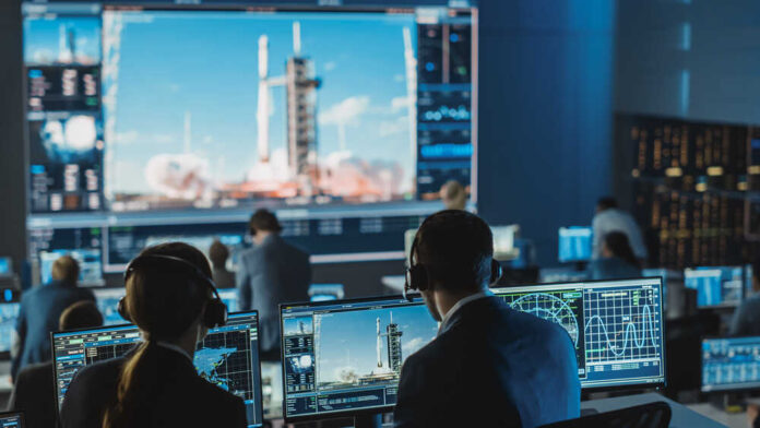 Group,Of,People,In,Mission,Control,Center,Witness,Successful,Space