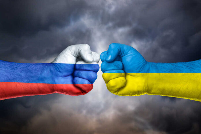 Flags,Of,Russia,And,Ukraine,Painted,On,Two,Fists,On