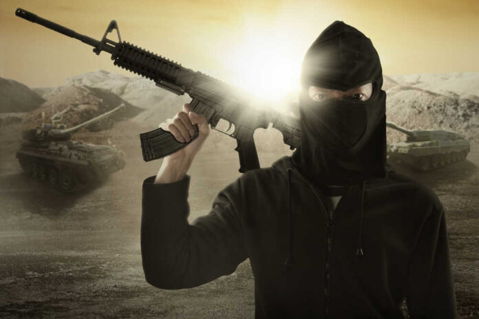 Male,Terrorist,Wearing,Mask,And,Holding,A,Machine,Gun,With