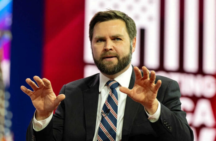 I dont know who this is. Man speaking with hands raised.