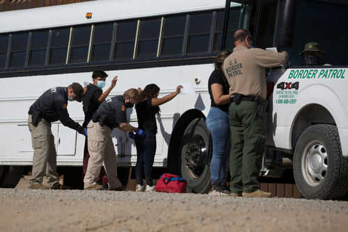 People being searched by border patrol officers