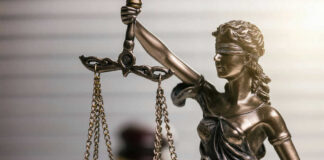 Bronze statue of Lady Justice holding scales.