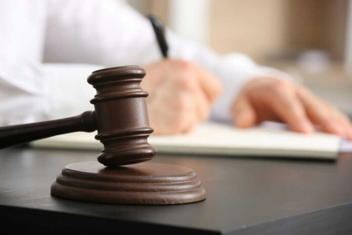 gavel, a man holding a pen