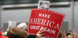 Person holding Make America Great Again sign