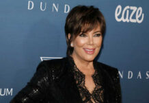 A woman in a glamorous outfit smiling at a celebrity event