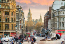 View of London with Big Ben in the background and lion statues in the foreground