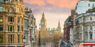 View of London with Big Ben in the background and lion statues in the foreground