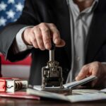 Visa Revocations: A Blow to Chile-China Ties A person stamping passports on a desk with various stamps and documents