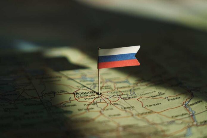 shutterstock_2533443209.jpg A small Russian flag pinned on a map of Moscow