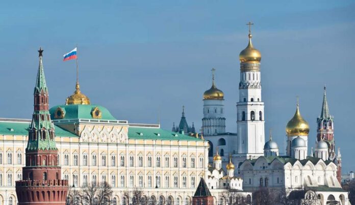 View of the Kremlin with golden domes and the Russian flag
