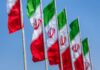 Massive $10M Reward: Hunt for Iran’s Top Brass Multiple Iranian flags waving against a clear blue sky