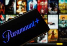 Mobile device displaying the Paramount Plus logo with a movie selection in the background