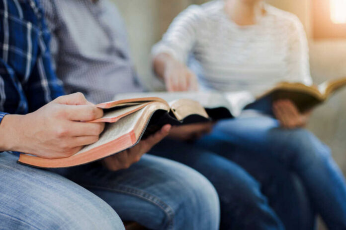 group of people reading bibles