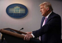 Trump Messaging Whiplash—What’s The Real Goal? Man speaking at a podium in a room