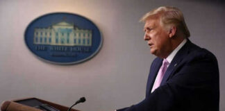 Man speaking at a podium in a room