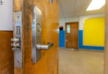 Door opening into an empty classroom.