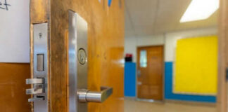 Door opening into an empty classroom.