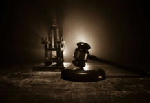 Gavel and electric chair in dimly lit room