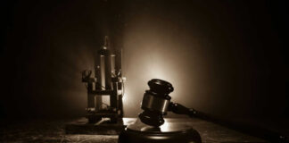 Gavel and electric chair in dimly lit room