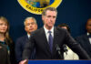 Person speaks at podium with California seal behind.