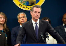 Person speaks at podium with California seal behind.