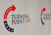 Logo of Turning Point USA displayed on a backdrop