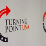 Logo of Turning Point USA displayed on a backdrop