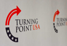 Serious Threats Rock TPUSA’s Georgia Event Logo of Turning Point USA displayed on a backdrop