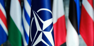 NATO flag in front of various national flags