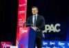 A speaker at a podium during a CPAC event