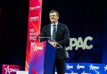 A speaker at a podium during a CPAC event