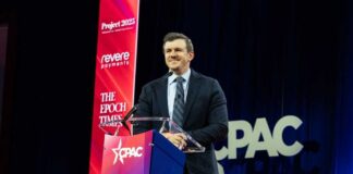 A speaker at a podium during a CPAC event