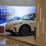 A sleek electric vehicle displayed in a modern showroom