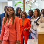 A diverse group of people smiling and walking together at an event