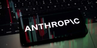 Smartphone displaying the word 'ANTHROPIC' over a background of financial graphs