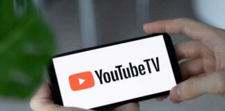 Hands holding phone with YouTube TV logo displayed