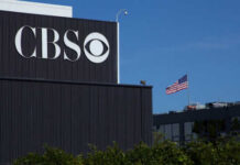 60 Minutes Veteran Walks Out—What Did Weiss Uncover? CBS sign on building, American flag in background.
