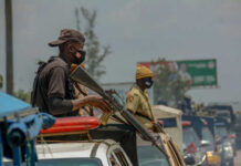 Nigeria’s Bold Move: Joining U.S. in ISIS Takedown Armed security personnel on vehicles in traffic jam
