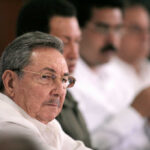 Elderly man in glasses at a conference table