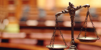 Close-up of a decorative scales of justice in a courtroom setting