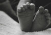 Unborn Child Debate: Hidden Truths REVEALED Close-up of a baby's feet resting on a soft surface