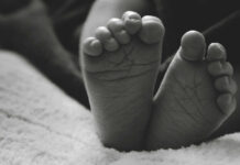 Unborn Child Debate: Hidden Truths REVEALED Close-up of a baby's feet resting on a soft surface