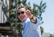 Man giving a thumbs up while wearing sunglasses