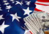 American flag with hundred dollar bills