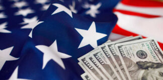 American flag with hundred dollar bills