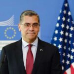 Becerra’s Unexpected LEAD – California’s Political Shocker A political figure standing in front of European and American flags