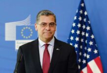 Becerra’s Unexpected LEAD – California’s Political Shocker A political figure standing in front of European and American flags