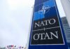 Robot War Zone: NATO’s Bold Move Near Russia NATO sign with flags in the background