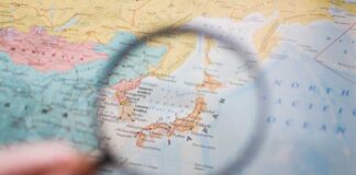 A magnifying glass focusing on a map of Japan